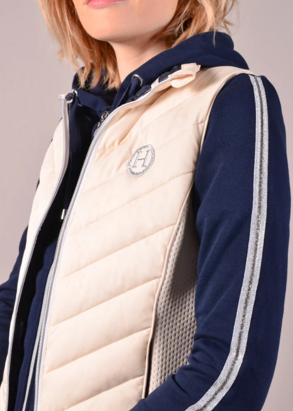 Navy jacket with a white quilted vest featuring a logo on a neutral background