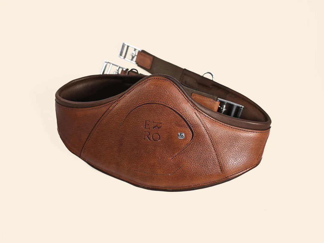 Brown leather belt with a visible brand logo on a beige background