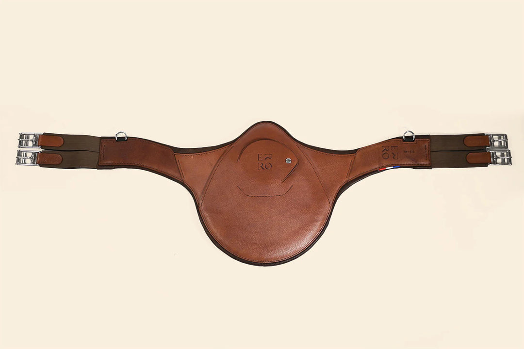 Brown leather girth strap on a beige background