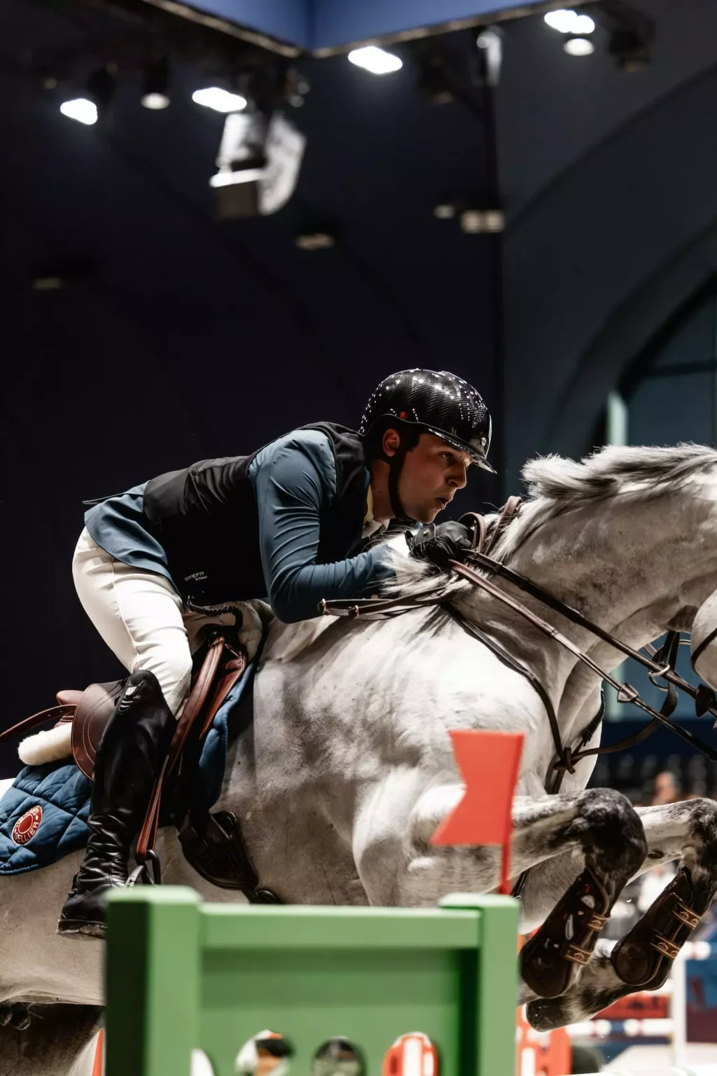 Equestrian rider jumping over an obstacle during a competition.